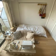 a bed sitting in the middle of a bedroom next to a window