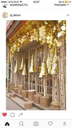 a bunch of bells that are hanging from the side of a building with gold decorations on it