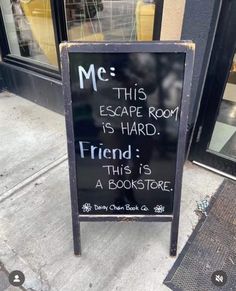 a sign on the sidewalk that says, me this escape room is hard friend is a bookstore