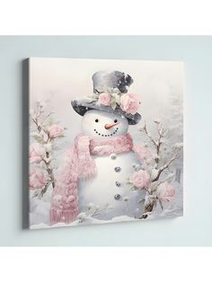 a snowman wearing a pink scarf and hat with flowers on it's head