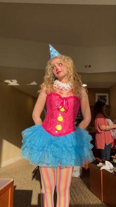 a woman dressed up as a clown in a room