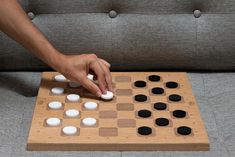 a person playing a board game on a couch