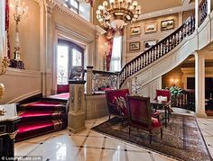 an elegant foyer with red and gold decor