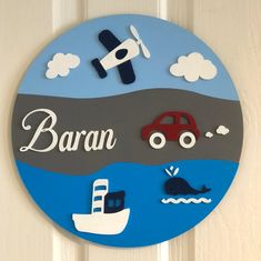 a wooden sign that says barn on the side of a door with cars and boats