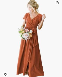 a woman in an orange dress holding a bouquet