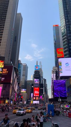 people are sitting on the sidewalk in times square