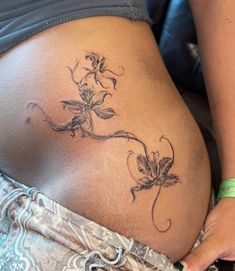 a woman's stomach with flowers on it and the bottom part of her belly