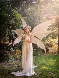 a woman dressed as a fairy holding flowers