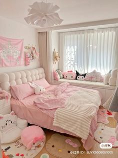 a bedroom decorated in pink and white with hello kitty decorations