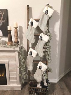 stockings hung on a ladder in front of a fireplace