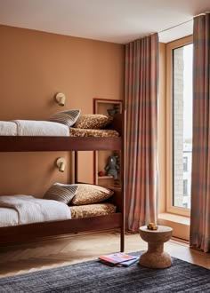 a bedroom with bunk beds and curtains in it