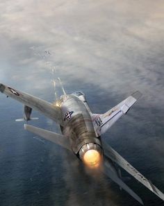 a fighter jet flying through the air with its lights on