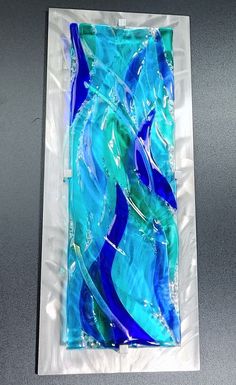 a piece of art made out of glass sitting on top of a plastic wrapper