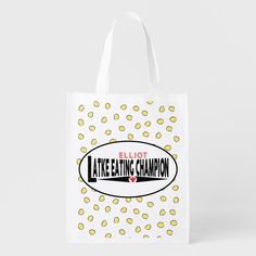 a white bag with yellow dots on it and the words, eliot like eating champion