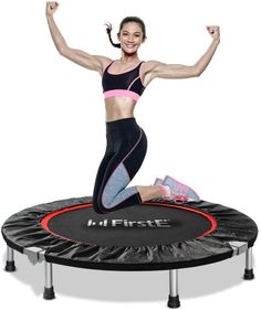 a woman standing on top of a trampoline with her arms in the air