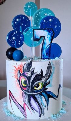 a birthday cake decorated with an image of a cat and number one on it's side