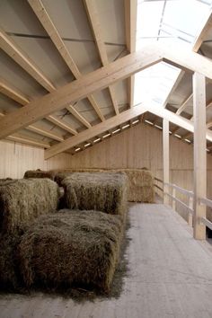 hay bales in a barn with wooden beams