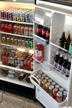 an open refrigerator filled with lots of different types of beer and sodas in it