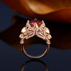 The powerful Lion represents unrivaled courage and strength. Crafted in sterling silver, this ring features a round cut center stone warpped by two lively lions, while additional stones adorn the ring to add more sparkles. The red stone set on the center of the ring adds a sense of mystery to this ring. As a strong and brave figure, you will be ready to take on any challenge when you wear this ring.Carat Weight: 6.46 ctStone Size: 10 mmStone Type: Jeulia® StoneNumber of Stones: 1 Stone Shape: RoundStone Color: Garnet RedCarat Weight: 1.66 ctStone Size: 1,1.2,0.8 mmStone Type: Jeulia® StoneNumber of Stones: 200 Stone Shape: RoundStone Color: Diamond WhiteWeight: 9 gWidth: 4.6 mmHeight: 13 mmThickness: 1.6 mmMaterial: 925 SilverPlating Color: Rose Gold Lion Ring Gold, Lion Ring, Women Diamond, Red Stone, Garnet Rings, Round Cut, Stone Settings, Garnet, Women Rings