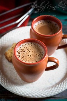 two cups of hot chocolate on a plate