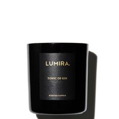 a candle that is black and has gold lettering on the front, which reads lumira no 612