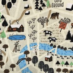 an embroidered map with trees, houses and animals in the background that says card ground