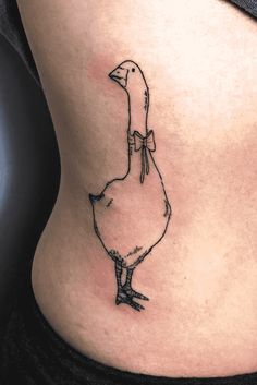 a woman's stomach with a small tattoo of a duck