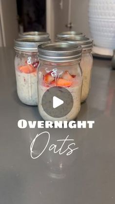 two jars filled with food sitting on top of a table