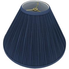 a blue lamp shade with a gold clock on the top and bottom, sitting in front of a white background