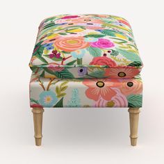 the foot stool is decorated with colorful flowers and leaves on it's sides,