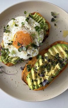 an egg and avocado toast on a plate