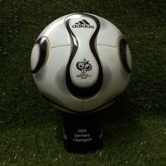 a soccer ball sitting on top of a green field