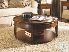 a living room with a coffee table on top of a carpeted floor next to a couch