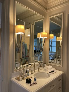 a bathroom sink sitting under two large mirrors