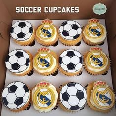 cupcakes in a box with soccer balls on them