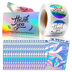 two rolls of thank you holographic stickers next to each other on a white background