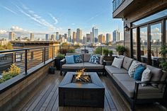 an outdoor living area with couches, tables and a fire pit in front of the city skyline