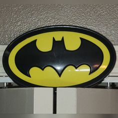 a batman sign hanging from the side of a door