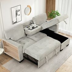 a living room with a sectional sofa and coffee table in the middle, on top of a rug