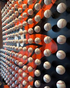 baseballs and bats are arranged on the wall