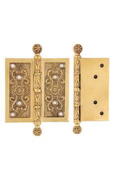 two brass door handles with decorative designs on them