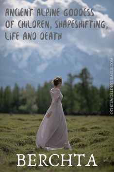 a woman in a white dress is walking through the grass with mountains in the background