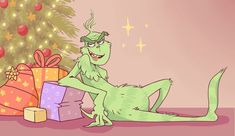 a green cat sitting in front of a christmas tree with presents around it and a gift box