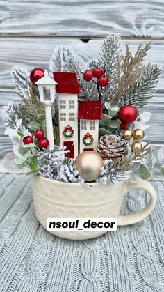 a cup filled with christmas decorations on top of a table