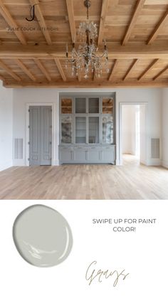 an empty room with white walls and wood floors, the paint color is swipe up for