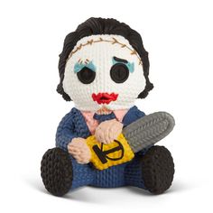 a knitted toy with a creepy face holding a knife in it's hands