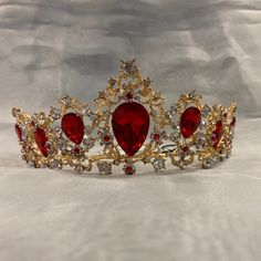 This Crown Features A Gold Tone With Beautiful Red Jewel Accents. Red And Gold Tiara Quince, Quince Crowns Red And Gold, Red And Gold Quinceanera Theme Tiara, Quince Crowns Flowers, Red Quinceanera Tiara, Red Circlet Crown, Burgundy Quinceanera Crown, Dark Red Quinceanera Crown, Dark Red And Gold Quinceanera Theme