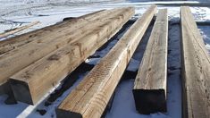 several pieces of wood sitting in the snow