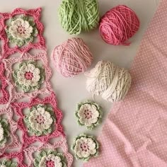 several balls of yarn and crochet on a table