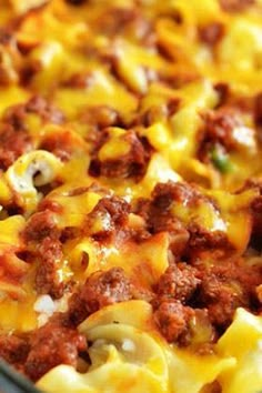 a close up of a pizza with cheese and meat